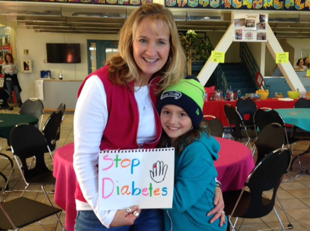 Mother and daughter holding a sign that says STOP DIABETES