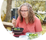 Melanie eats a health dinner outside on a warm summer day. She signed up for a free diabetes management program to help her lower her blood sugar.