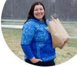 Brenda carries groceries from her car on a snowy day. She enrolled for Alaska's Tobacco Quit Line program to help her quit tobacco. She feels better and has more energy when she runs every day errands.