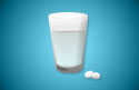 Glass of water with emergency contraception pills