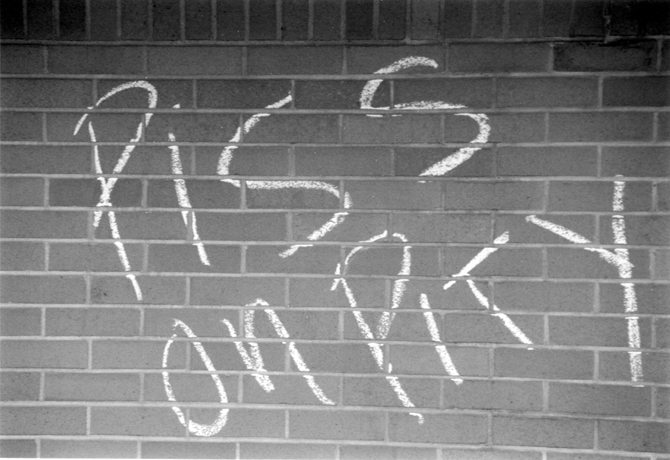 Brick Wall with graffiti reading  Piss on Pity