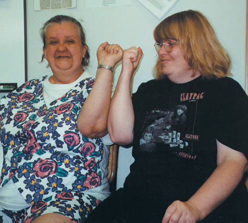 Photo of two advocates raising fists together