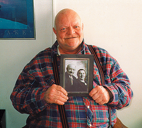 Photo of man holding photograph