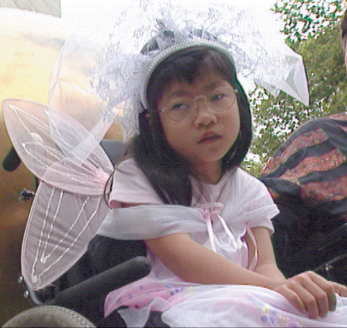 Photo of young girl in fairy wings and princess crown